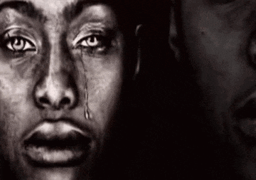 a black and white photo of a man 's face with a tear running down his eye .