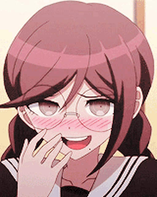 a close up of a girl wearing glasses and making a funny face .