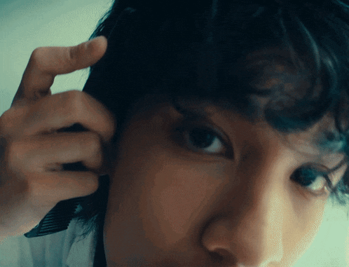 a close up of a person 's face with a comb on it