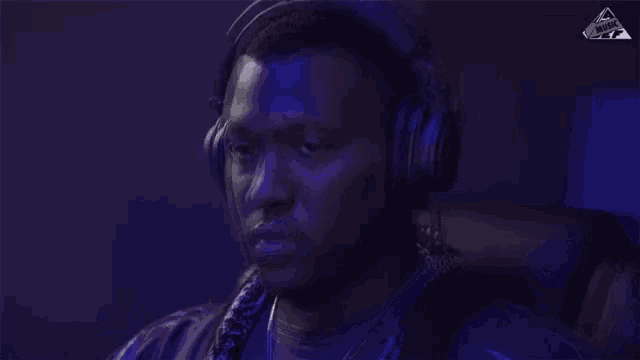 a man wearing headphones has the word music on the bottom right