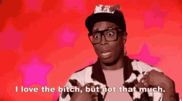 a man wearing glasses and a cow print jacket says i love the bitch but not that much