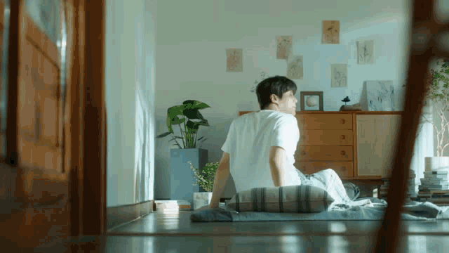 a man is sitting on the floor in a room