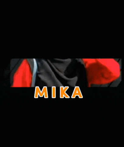 a woman wearing a hijab and a red shirt is standing in front of a black wall .