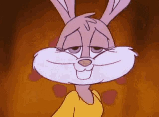 a close up of a cartoon rabbit wearing a yellow shirt .