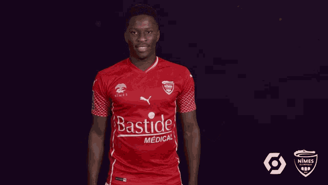 a man in a red bastide medical jersey