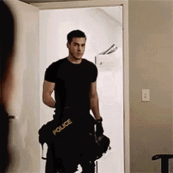 a man in a police uniform is standing in a doorway