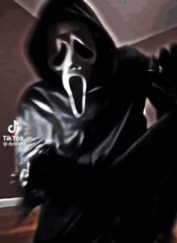 a man in a scream mask is taking a selfie