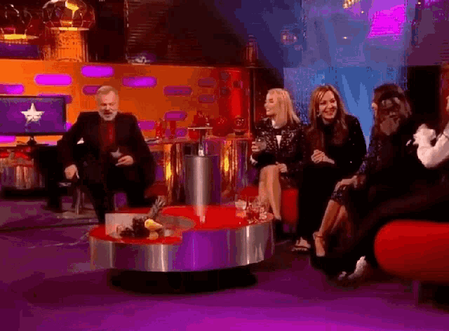 a group of people are sitting around a table with a star on it
