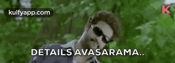 a man wearing sunglasses is laying down in the woods with a caption that says `` details avasarama '' .