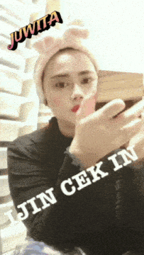 a woman wearing bunny ears and a headband with the words juwita jin cek in