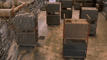 a warehouse filled with lots of bricks stacked on pallets