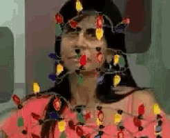 a woman with christmas lights on her face and neck