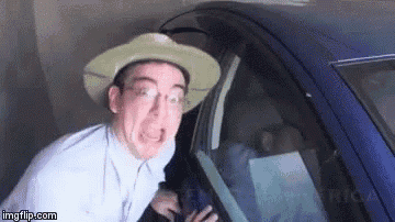 a man wearing a cowboy hat and glasses is making a funny face while getting out of a blue car .