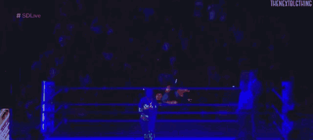 a blurry picture of a person in a wrestling ring with the words the next big thing on the bottom