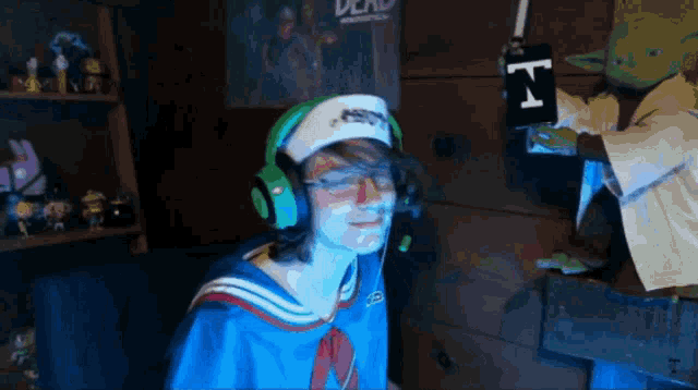 a person wearing headphones and a hat with the letter n