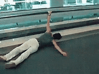 a man is laying on the floor with his arms outstretched .