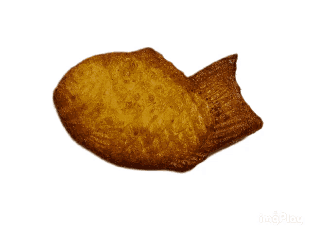 a close up of a fish shaped cookie with a bite taken out of it on a white background