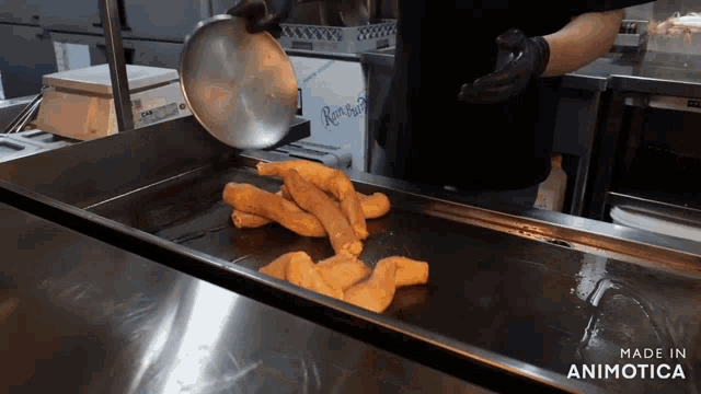 a tray of food is being cooked in a kitchen with the words made in animotica visible