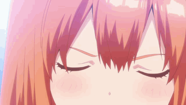 a close up of a girl 's face with blue eyes and orange hair
