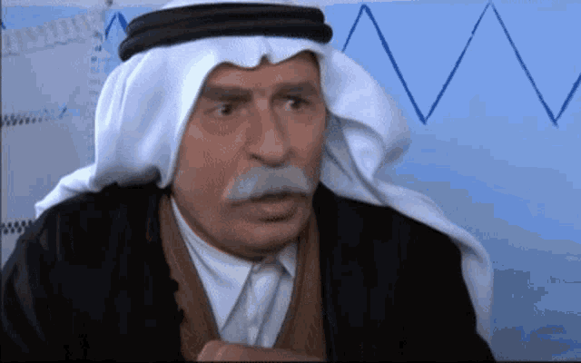 a man with a mustache and a white head scarf