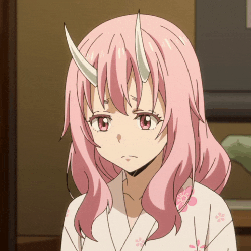 a girl with pink hair and horns looks sad