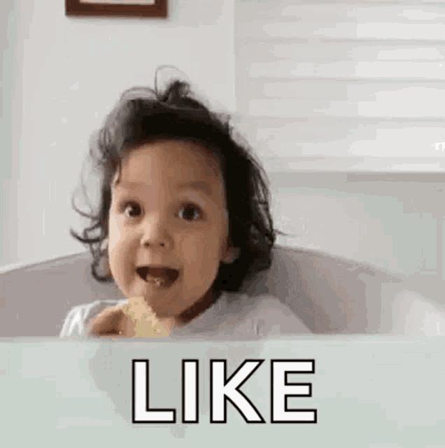 a little girl is sitting in a bathtub eating a piece of food and making a face .