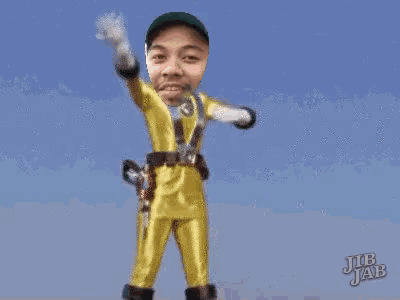 a man in a yellow superhero costume has a green hat on his head