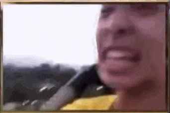 a close up of a person 's face with a blurred background .