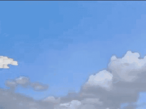 a man is riding a gorilla with angel wings in the clouds