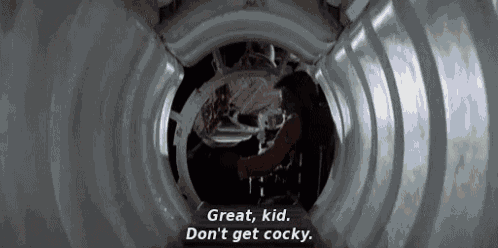 a man is standing in a tunnel and talking to another man .