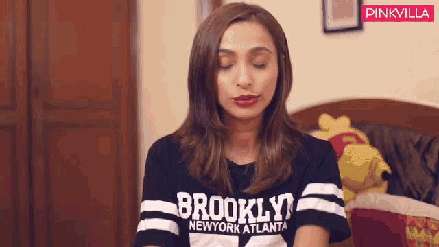 a woman wearing a brooklyn new york atlanta shirt