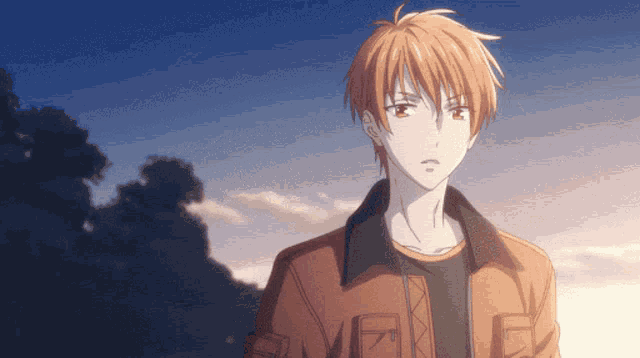 a man with orange hair is wearing a jacket with the letter e on it