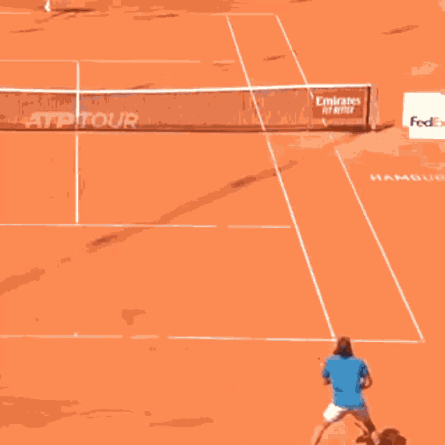 a tennis court with an emirates for better banner on the net