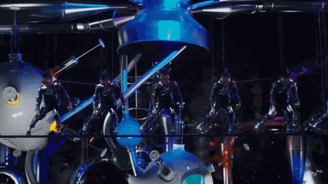 a group of people in futuristic costumes are standing in front of a machine with a blue light coming out of it