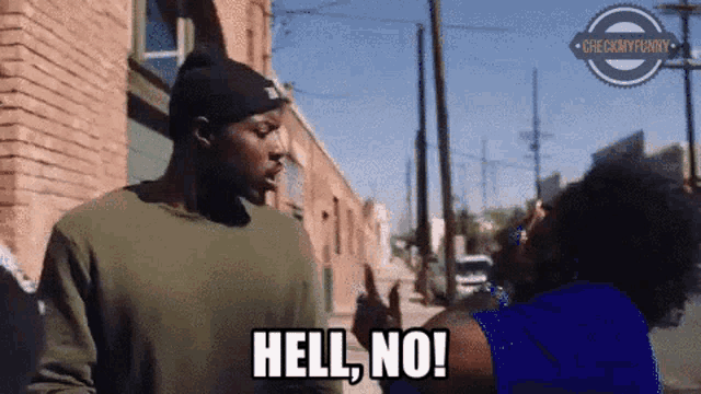 a man and a woman are standing on a street and the woman is saying hell no .