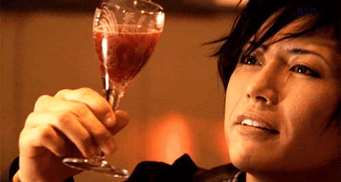 a woman holding a wine glass with the word bsn in the corner