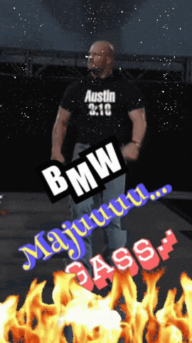 a man in a bmw shirt stands in front of a fire