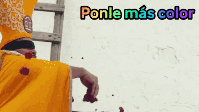 a man in a yellow robe is throwing flowers in the air with the caption ponle mas color