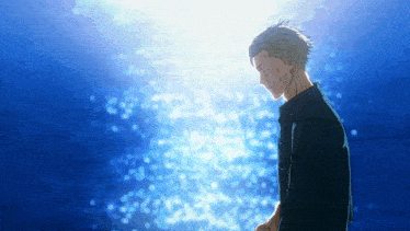 a man is standing in front of a blue background