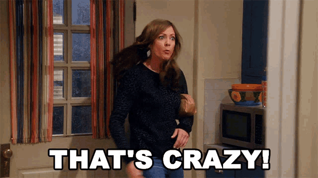a woman standing in a kitchen with the words that 's crazy