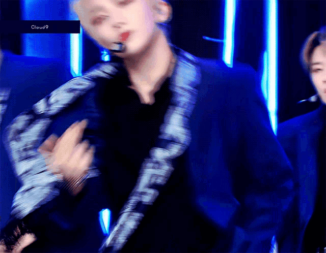 a blurry picture of a man in a blue suit with the word cloud9 on the bottom