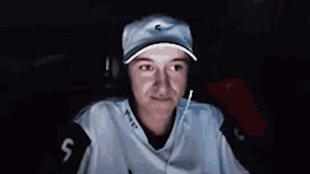 a person wearing a hat and headphones with the number 5 on their shirt