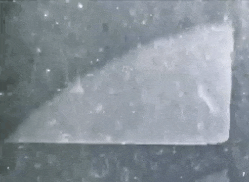 a black and white photo of a piece of paper on a table