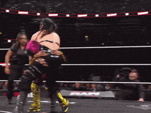 two women are wrestling in a ring with the word raw on the side