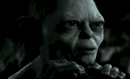 a close up of a gollum from the lord of the rings eating a piece of food .