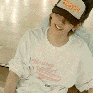 a person standing on a wooden floor with a foreign language written on the floor