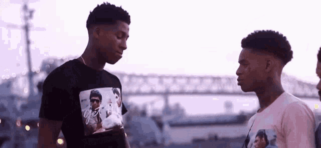 two men are standing next to each other and one has a t-shirt with a picture of michael jackson on it