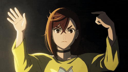 a girl in a yellow shirt has her hands up