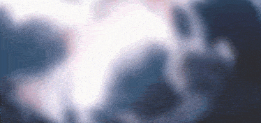 a blurred image of a person 's face with a blue background .
