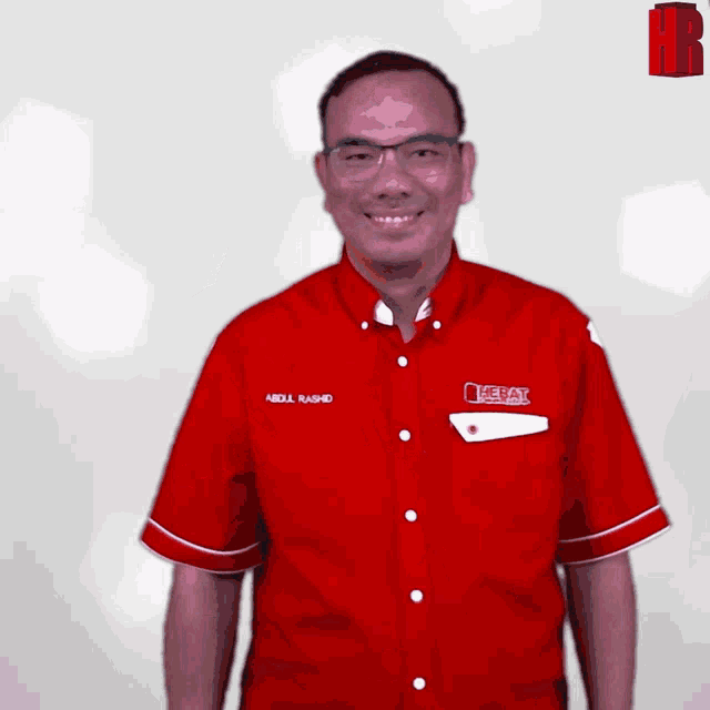 a man wearing a red shirt that says abdul rashid